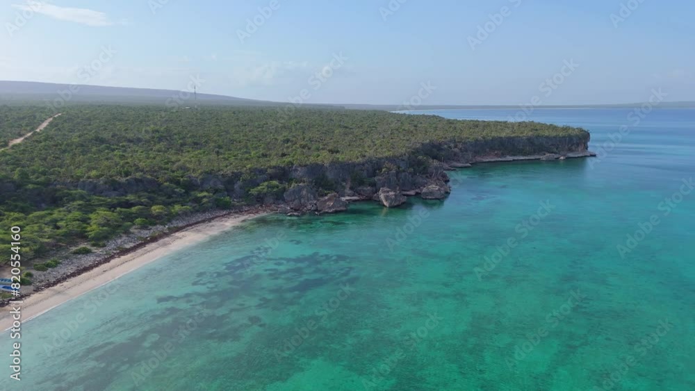 Jaragua national Park with turquoise colored coastline in Pedernales. Tropical mangrove plants and fauna in sunlight. Aerial forward wide shot. Jaragua national Park with turquoise colored coastline in Pedernales. Tropical mangrove plants and fauna in sunlight. Aerial forward wide shot.