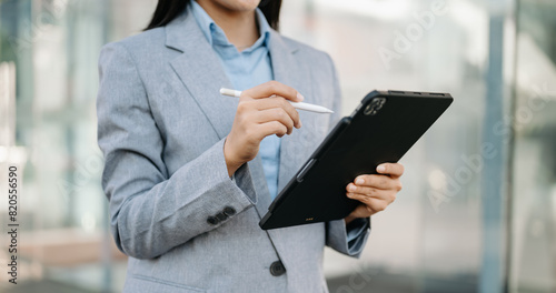 Confident businessman working on laptop,tablet and smartphone at her workplace ..