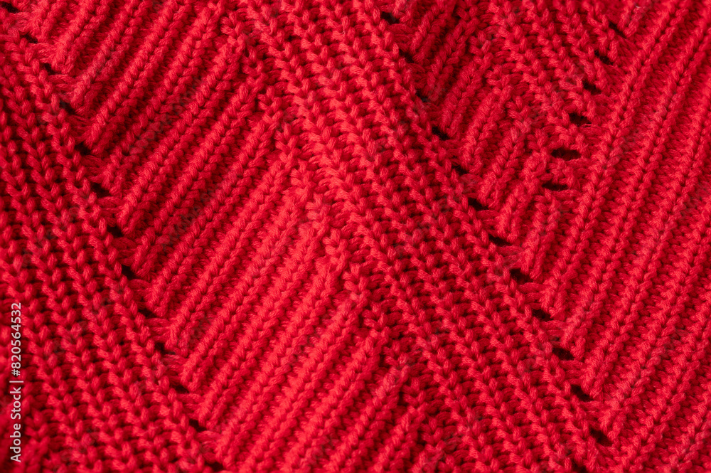 Red knitted mesh fabric texture, close up