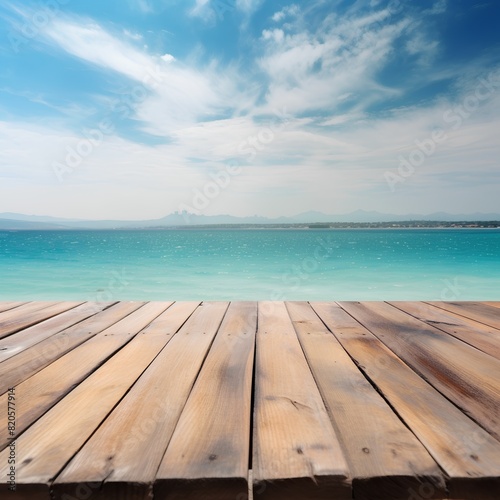 Empty wooden deck table over turquoise sea and blue sky background