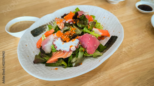 various kind of fresh raw sashimi salad, Japanese spicy salad sashimi salmon with Premium fresh raw salmon. Asian salad with tofu and fresh vegetables Mixed sliced fish sashimi, thin sliced raw meat 