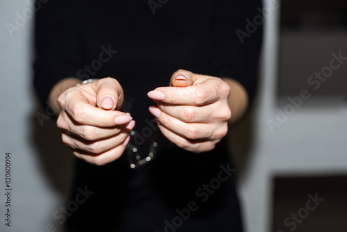 prisoner woman, prisoner's hands are handcuffed behind her back.