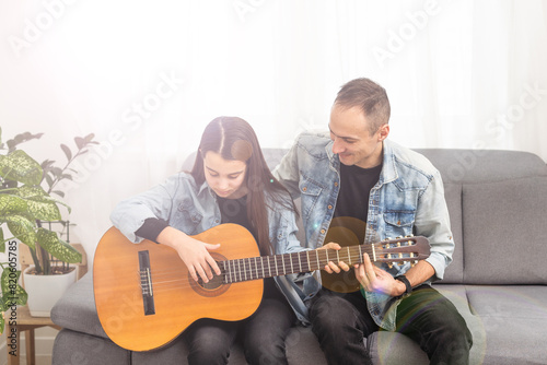 Guitar teacher teaching the little girl