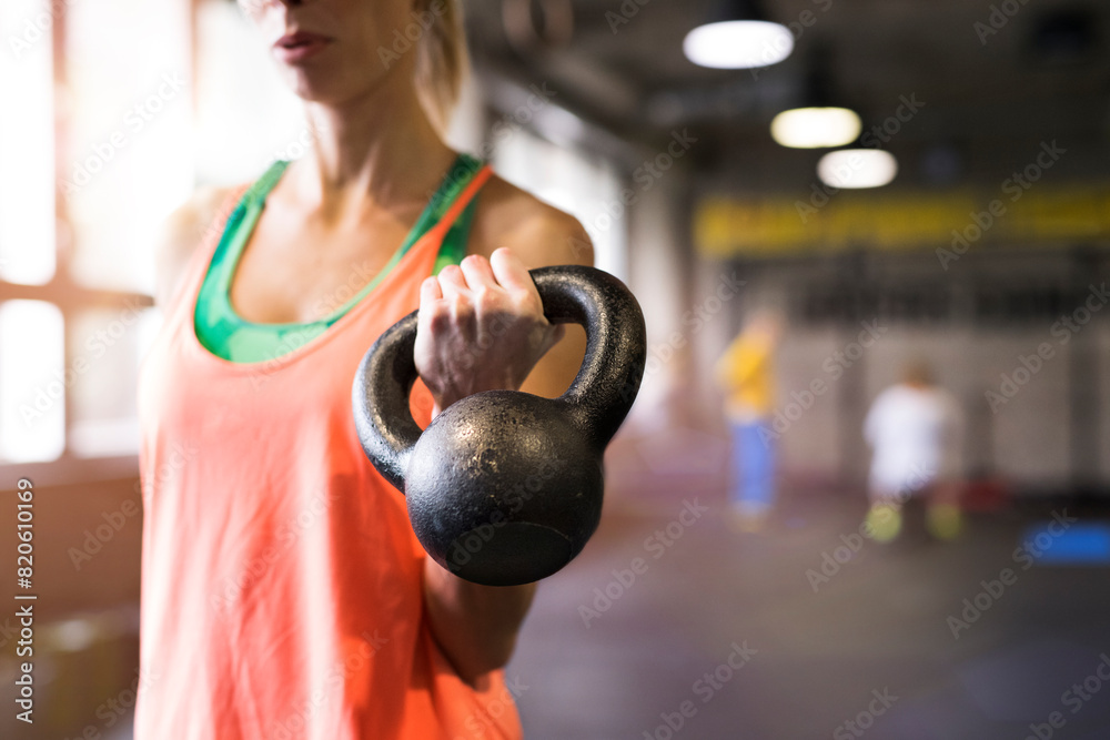 Beautiful sport woman exercising with kettlebell. Routine workout for woman's physical and mental health. Beautiful sport woman exercising with kettlebell. Routine workout for woman's physical and mental health.