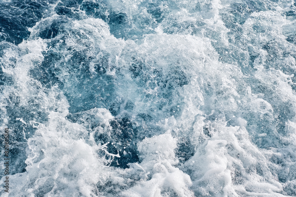 Sea waves, bubbles and white foam over the blue sea formed by the motor of a powerboat. Sea waves, bubbles and white foam over the blue sea formed by the motor of a powerboat.