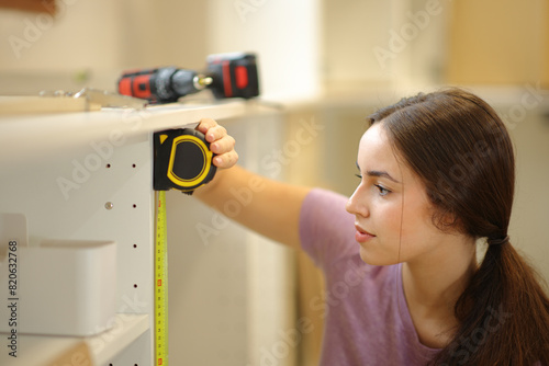 Woman taking measure with a measure tape