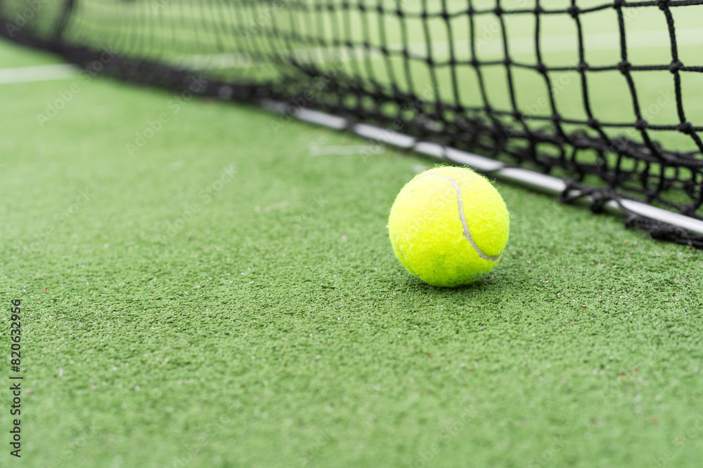 Tennis Ball on the Court against the Court Net Tennis Ball on the Court against the Court Net