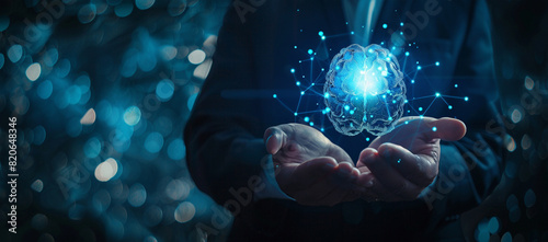 Businessman holding a brain hologram in his hands on a dark blue background with copy space