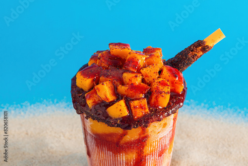 Mangonada, typical mexican mango smoothie on summer background. photo