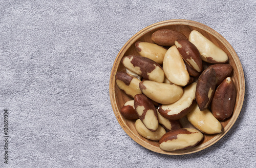 top view flat lay close up heap of brazil nut in wood bowl on white table food background copy space
