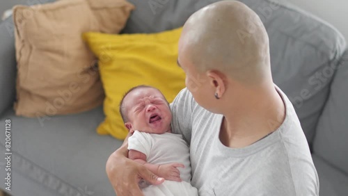 Asian Young Father Holding His Crying Baby In Living Room