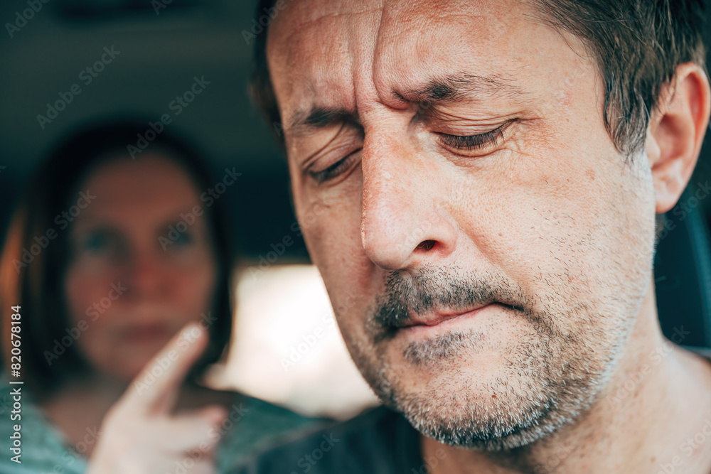 Fototapeta premium Couple arguing in car, male driver and female passenger during quarrel