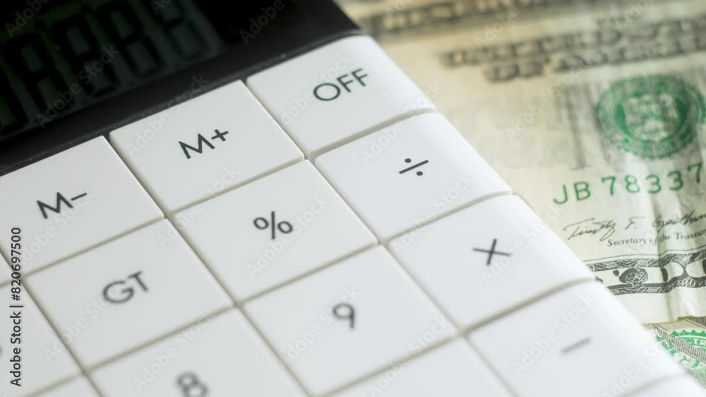 Counting on calculator Recession economy, inflation, investment, finance, savings, salary and payment concepts. Macro close up new modern calculator and dollars bills. Financial and money saving Counting on calculator Recession economy, inflation, investment, finance, savings, salary and payment concepts. Macro close up new modern calculator and dollars bills. Financial and money saving