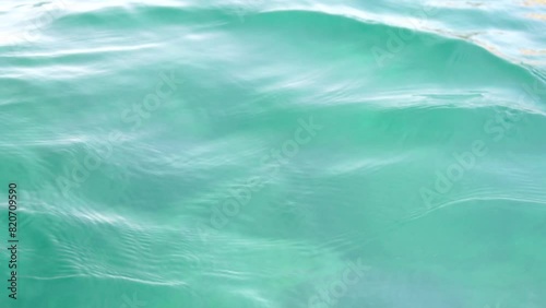 Sea water surface. Camera flies over the calm azure sea. Nobody. Holiday recreation concept. Abstract nautical summer ocean nature. Weather and climate change. Slow motion. Close up photo