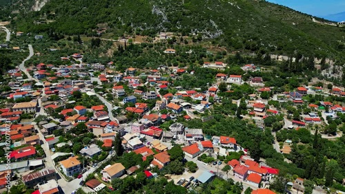 Beautiful township near green mountains in Zakynthos island, aerial drone view photo