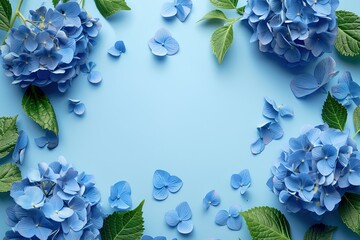 blue hydrangeas flowers border frame on light blue background top view, beautiful floral template with copy space