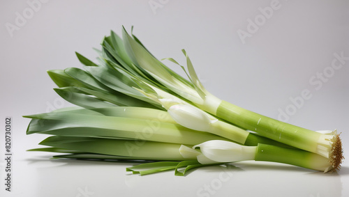 white onions with green stalks bundled on white background photo
