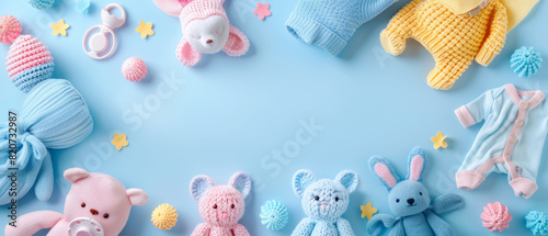 Adorable baby toys and clothes on pastel background photo