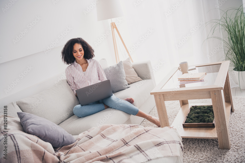 Photo of pretty cute adorable woman sitting on sofa working chatting white light interior living room indoors Photo of pretty cute adorable woman sitting on sofa working chatting white light interior living room indoors