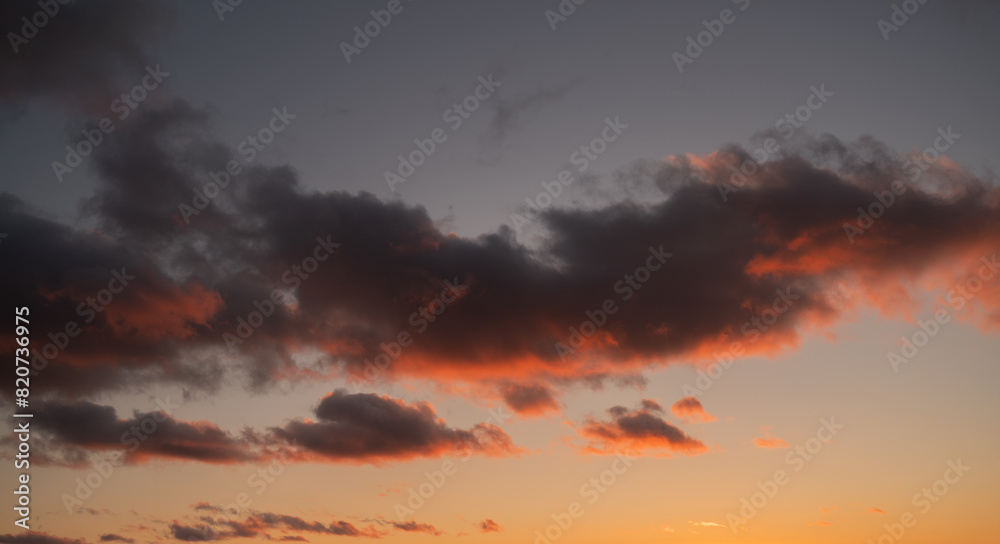 Sunset sky with orange clouds. Nature background.