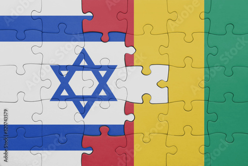 Fotografía puzzle with the colourful national flag of israel and flag of guinea