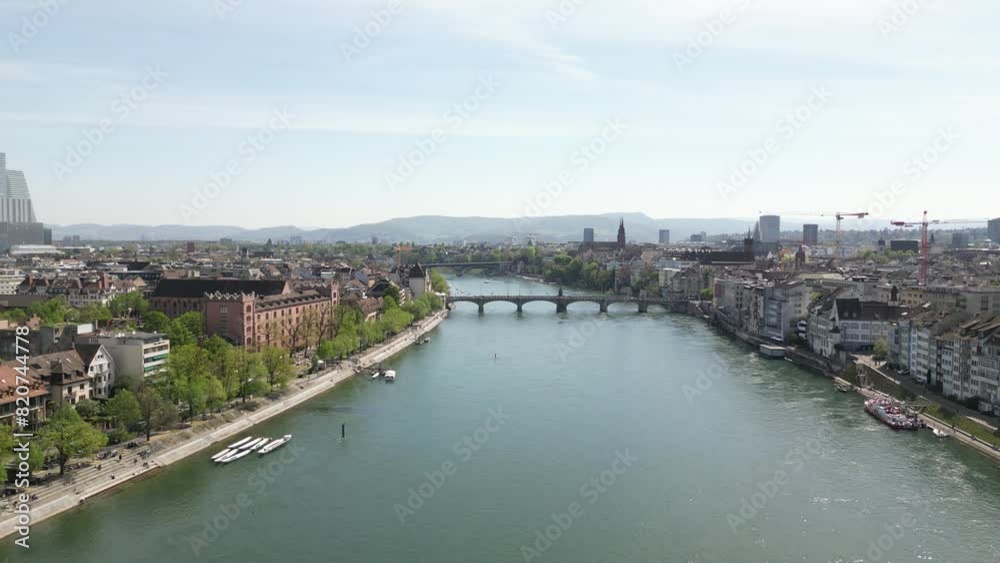 Aerial drone backward moving shot over Basel medieval old town along both sides of Rhine river in Switzerland at daytime. Aerial drone backward moving shot over Basel medieval old town along both sides of Rhine river in Switzerland at daytime.