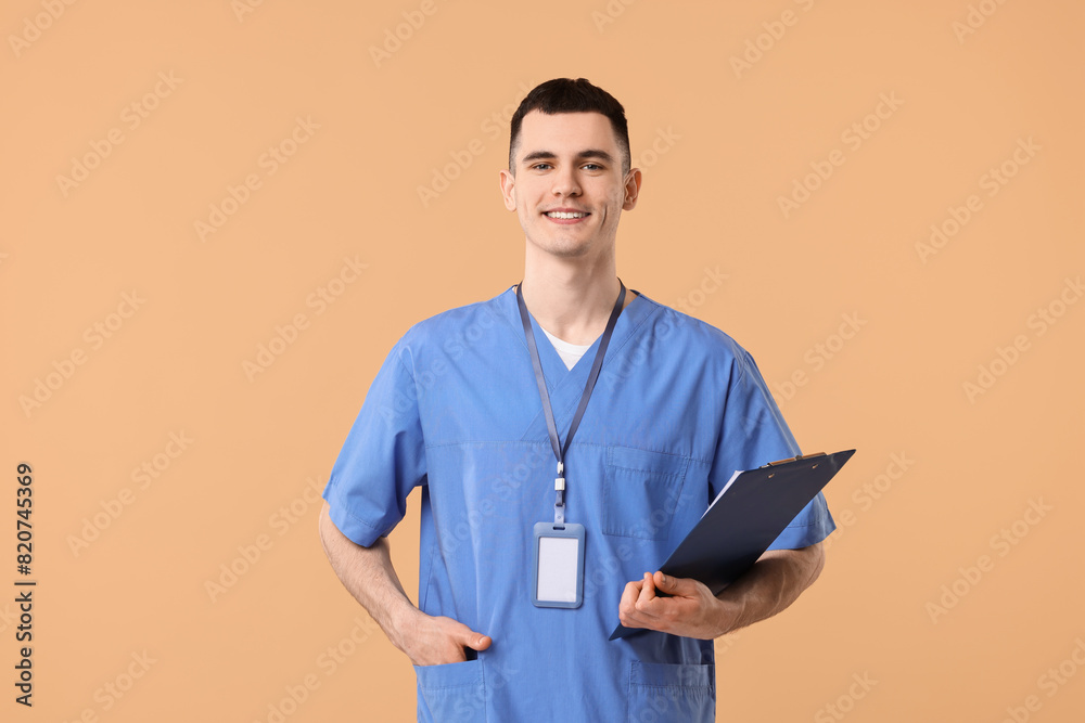 Portrait of smiling medical assistant with clipboard on beige background Portrait of smiling medical assistant with clipboard on beige background