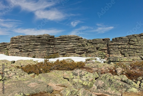 View of tor on top of Pyhä-Nattanen fell in spring with clouds in the sky, Sompio Strict Nature Reserve, Lapland, Finland.