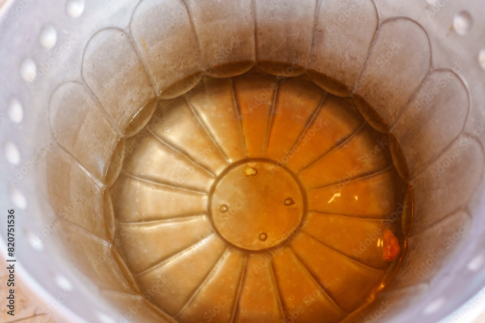 Fototapeta premium wax with cut hair in the water of the baptismal font. Christian faith and traditions.