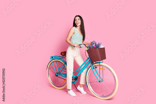 Photo of positive good mood cute woman wear trendy clothes look empty space isolated on pink color background © deagreez