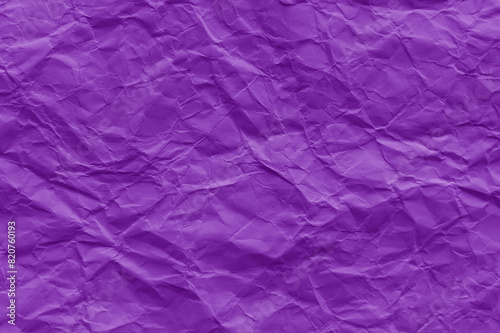 Crumpled purple violet paper texture background. Wrinkled paper surface. 