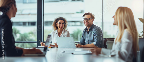 Happy business team working together in a conference room, with the leader smiling and laughing during a meeting at the office table. Suitable for illustrating teamwork and collaboration in corporate  photo