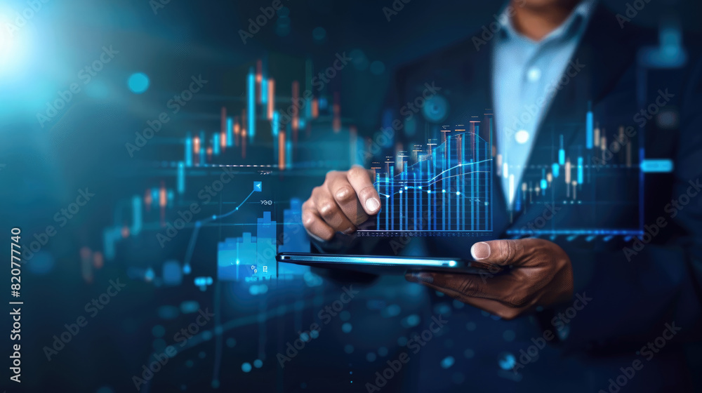 A businessperson in a suit is analyzing financial data on a digital tablet in an office setting at night, with futuristic graphics of stock charts and graphs overlaying the scene A businessperson in a suit is analyzing financial data on a digital tablet in an office setting at night, with futuristic graphics of stock charts and graphs overlaying the scene