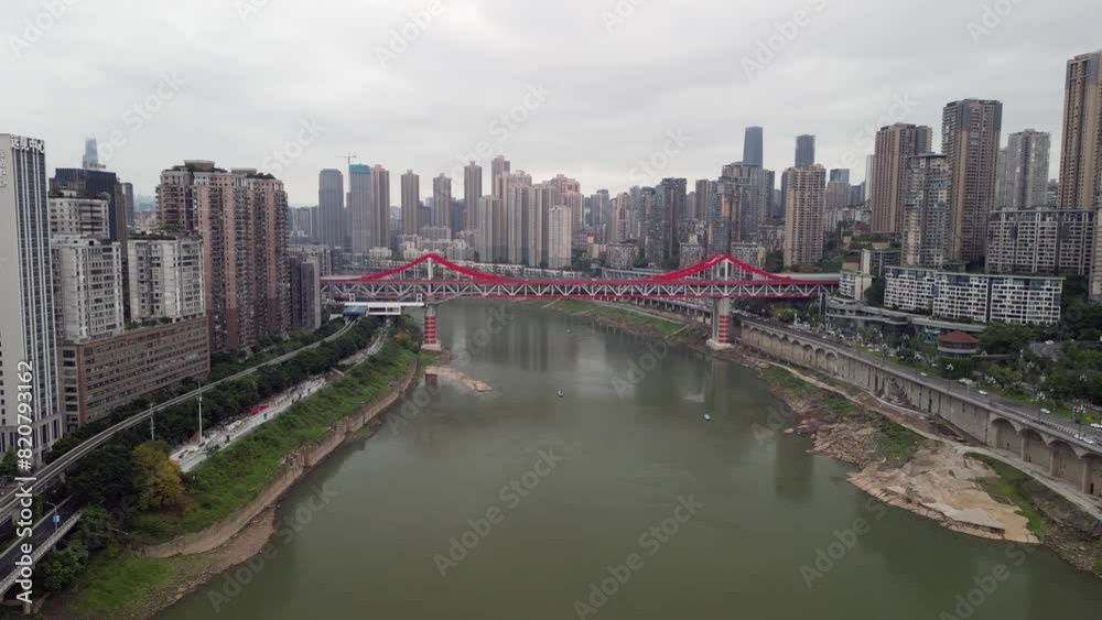 Drone view of a red bridge connecting two sides of a city Drone view of a red bridge connecting two sides of a city