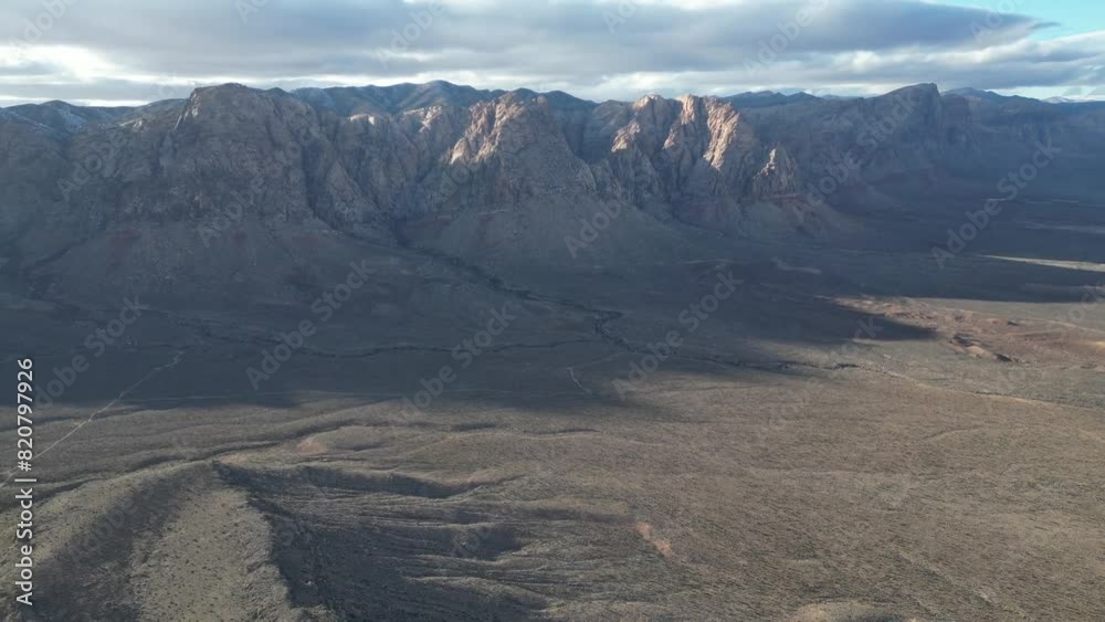 Aerial video of cars on the road surrounded by dry rocky high mountains Aerial video of cars on the road surrounded by dry rocky high mountains
