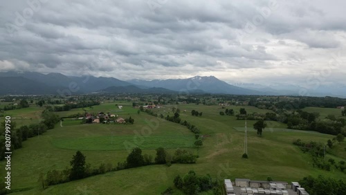 Wallpaper Mural Aerial video of a small village and fields with mountains in the background on a cloudy day Torontodigital.ca