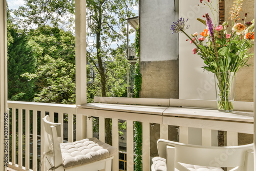 Cozy Balcony with Green View and Floral Decoration photo