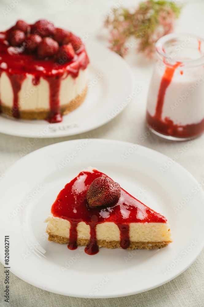Delicious slice of strawberry cheesecake on a plate. Delicious slice of strawberry cheesecake on a plate.