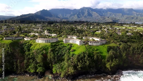 Aerial Shot of Luxury Condos in Princeville, HI with Emerald Mountains on Cliffs photo