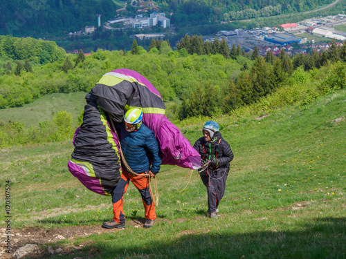 Two paragliders approach the takeoff area to fly in Brasov _ Romania