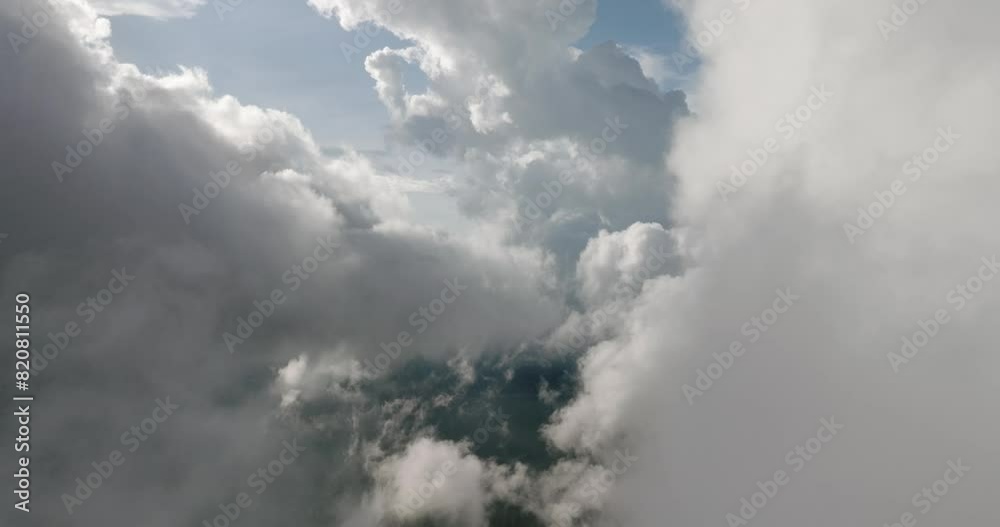 A sky filled with fluffy white cumulus clouds over a natural landscape A sky filled with fluffy white cumulus clouds over a natural landscape