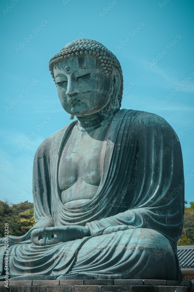 Large Buddha statue against a vivid blue sky in Kotoku-in temple in Japan Large Buddha statue against a vivid blue sky in Kotoku-in temple in Japan