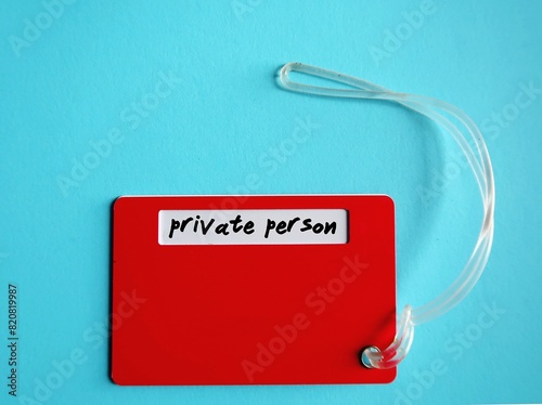 Red luggage tag with handwritten text PRIVATE PERSON, means person prefers to keep things on the down-low and doesn't find it easy to open up to other people