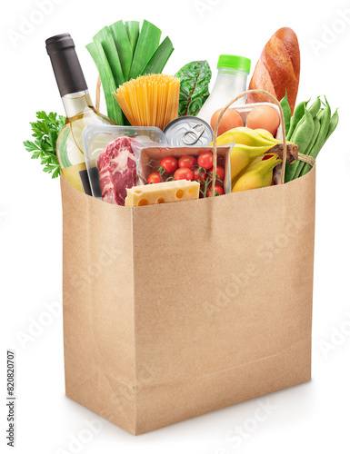 Reusable paper shopping  bag  full with fresh organic vegetables, fruits and other grocery products on white background. File contains clipping path.