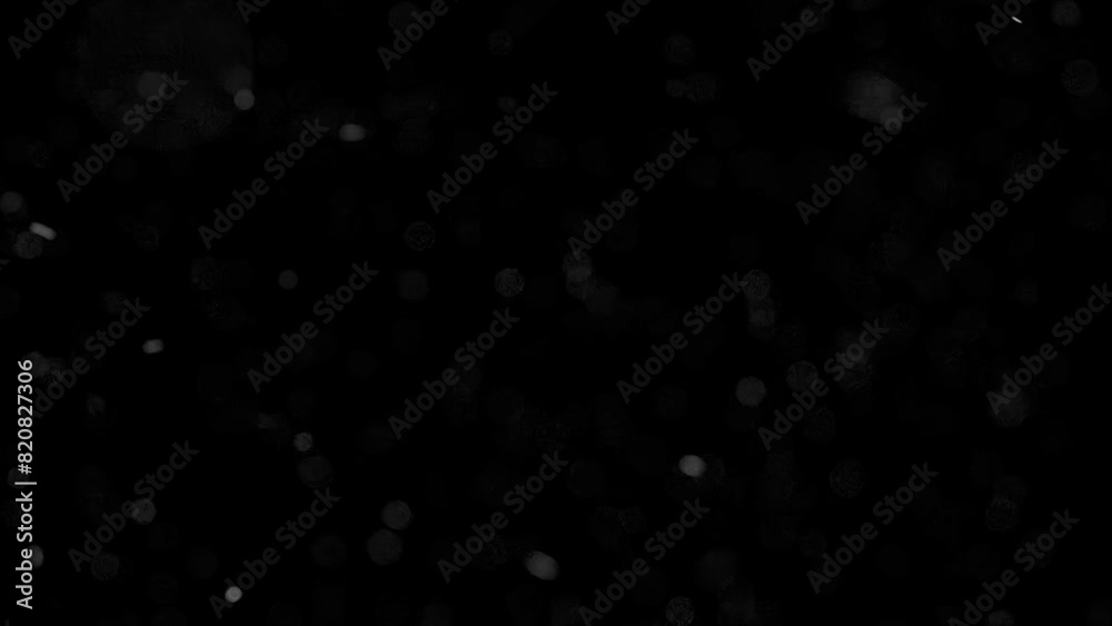 Animation of dust particles, ash, or snow floating in the wind. The black particle background is suitable for layer blending