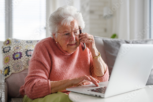 Senior woman working with laptop, shopping online, making call. Importance of digital literacy for elderly people. photo