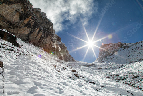 Snow covered mountains during snow storm with the sun shining in the Swiss Alps near Engelberg