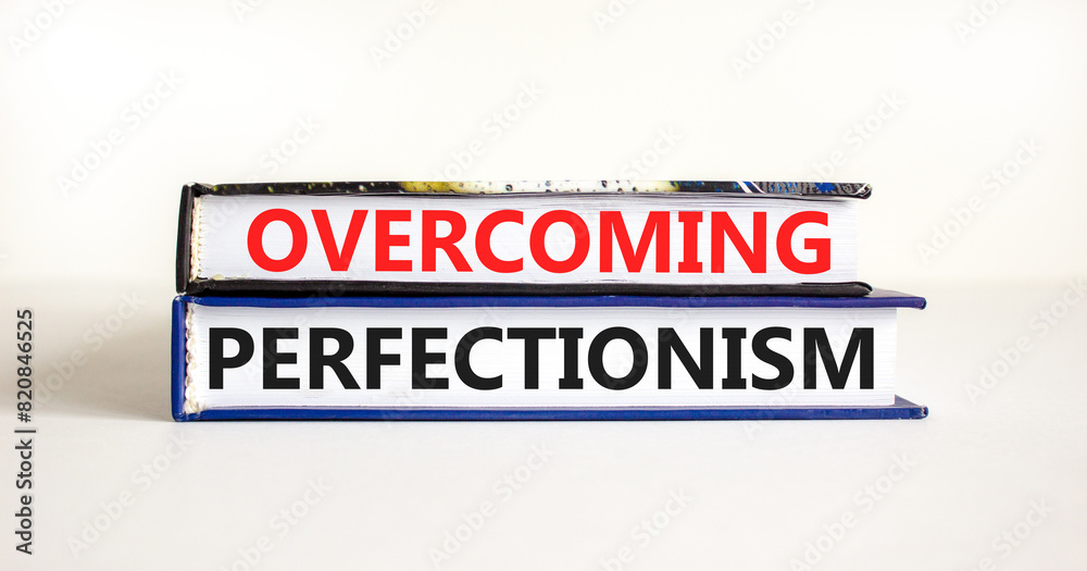 Obraz premium Overcoming perfectionism symbol. Concept words Overcoming perfectionism on beautiful books. Beautiful white paper background. Business Overcoming perfectionism concept. Copy space.