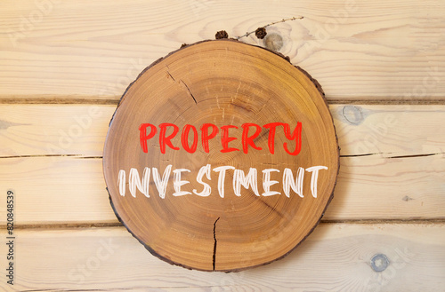 Property investment symbol. Concept words Property investment on beautiful wooden circle. Beautiful wooden wall background. Business Property investment concept. Copy space. © Dzmitry