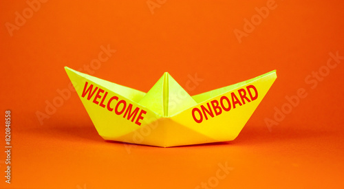 Welcome onboard symbol. Concept words Welcome onboard on beautiful yellow paper boat. Beautiful orange background. Business, motivational welcome onboard concept. Copy space. © Dzmitry